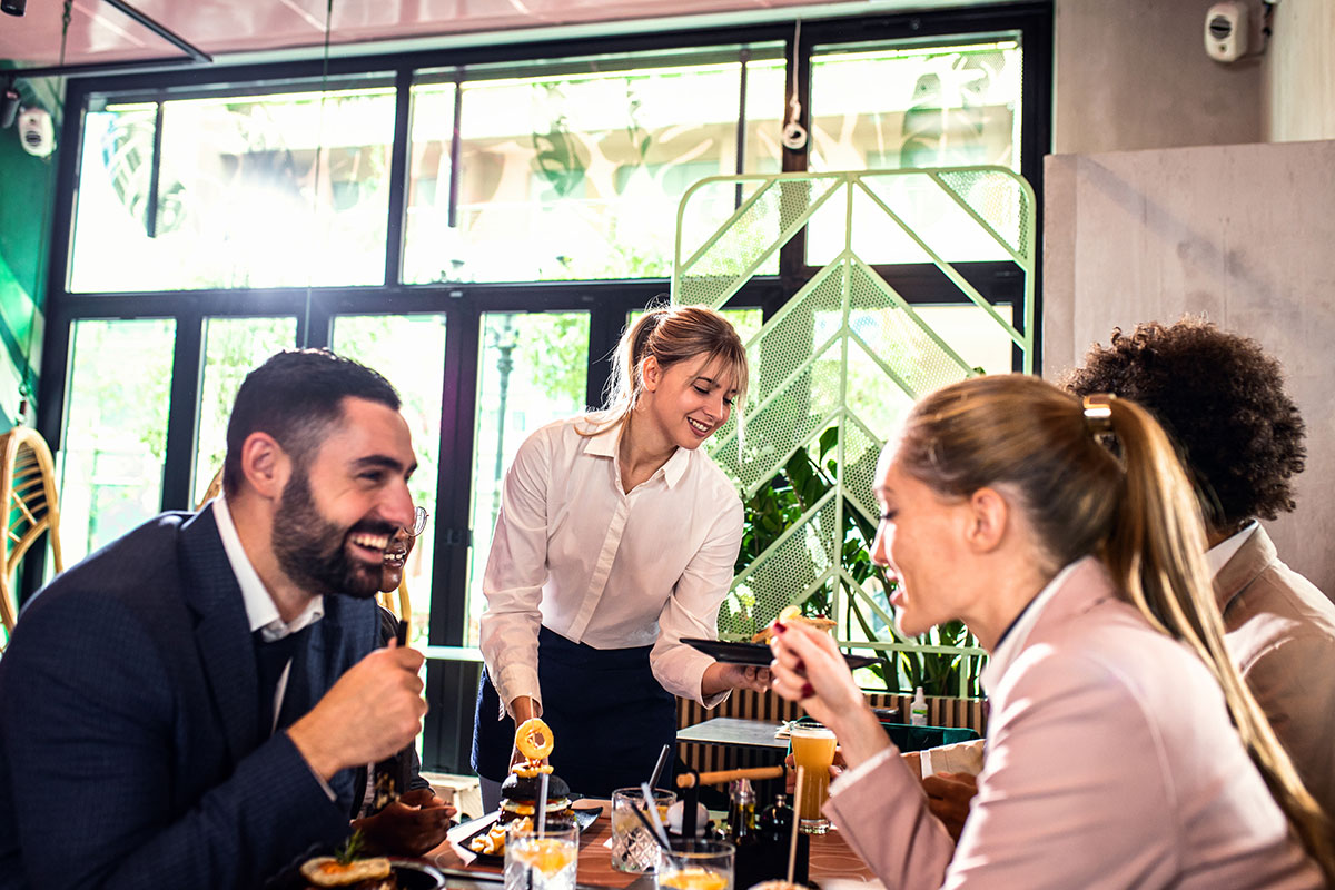 waitress smiling serving visitors
